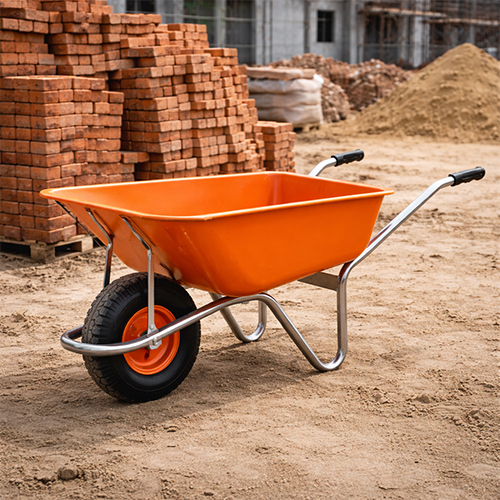 Heavy duty metal wheel barrow at a construction site in India.