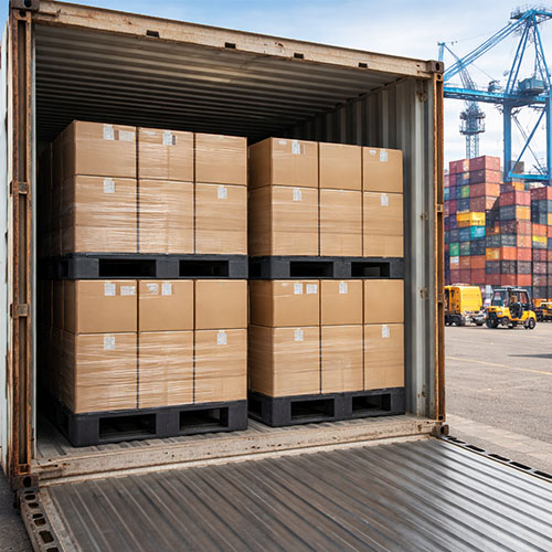Plastic export pallets being used to ship goods in a container from India.