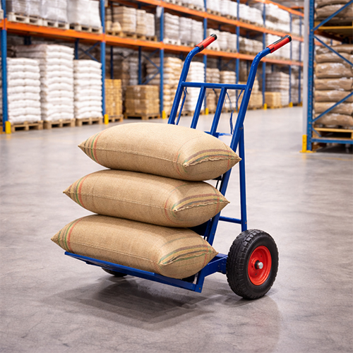 sack-truck-used-in-warehouse Heavy duty sack truck being used for material handling in an Indian warehouse.
